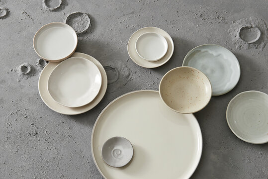 Ceramic tableware on grey background