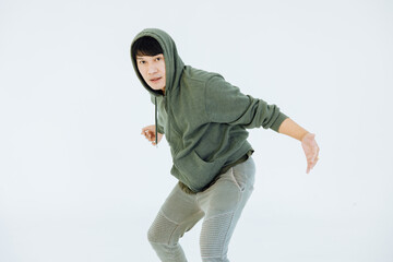 A man is performing a graceful dance in a white studio, performer masculine is a performance dancer, sportswear movement posing.