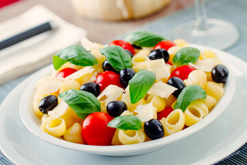 Fresh Pasta Salad with Tomatoes and Black Olives. High quality photo