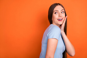 Obraz premium Profile photo of hooray long hairdo young lady hand face look empty space wear blue t-shirt isolated on vivid orange color background