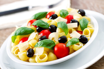Fresh Pasta Salad with Tomatoes and Black Olives. High quality photo