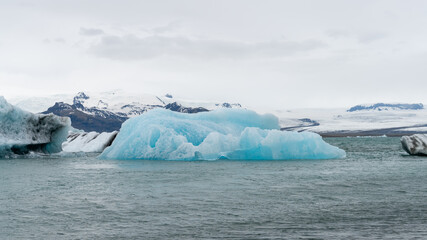 View of icebergs in Jokulsarlon glacier lagoon formed with melting ice, Iceland, global warming and climate change concept