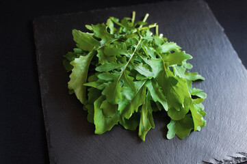 fresh arugula on a black board