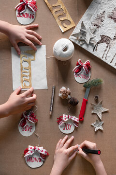 Two kids creating Christmas DIY projects