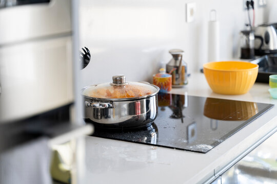 Detail of cooking pot with pumpking on stove in kitchen