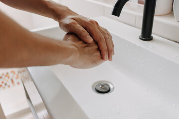 Washing hands with white foam in the toilet. Concept of cleaning and protection.