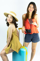 Portrait of Asian beautiful attractive woman smiling, holding passport  with suitcase for traveling in summer time while standing on isolated white cutout background.
