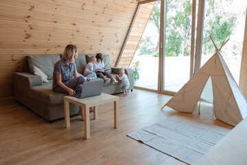 Working mother watching children reading book