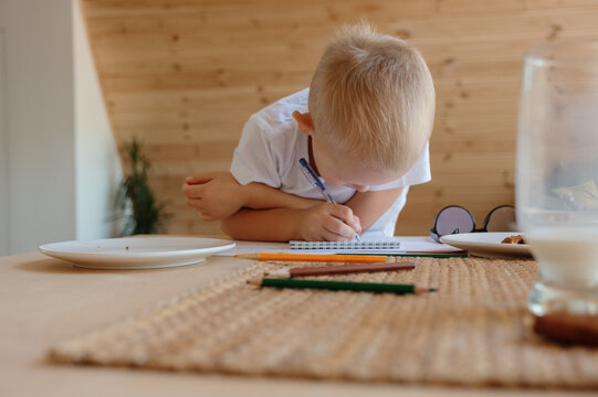 Focused boy writing in notepad