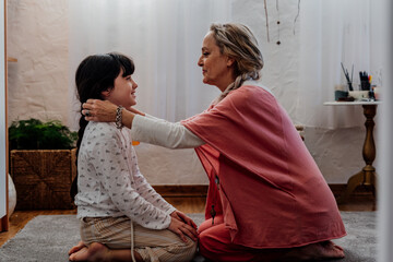 grandmother and granddaughter looking each other with tenderness 