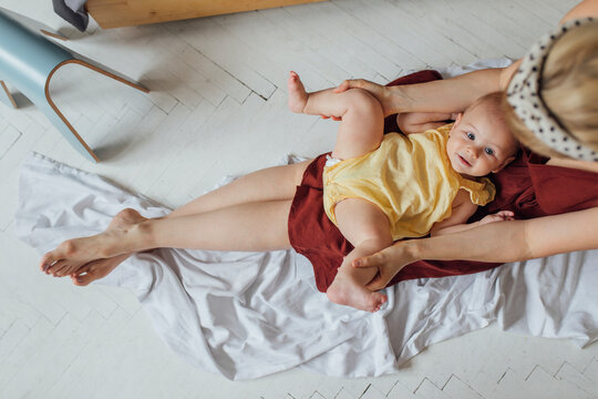 Motherhood: Carefully Holding Baby In Mothers Lap