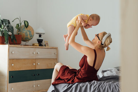 Motherhood: Happy Woman Playing Some Games With Her Kid Carefully