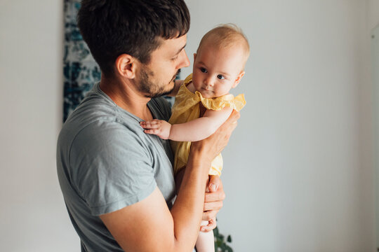 Sweet Baby Enjoying In Hugs From Caring Dad