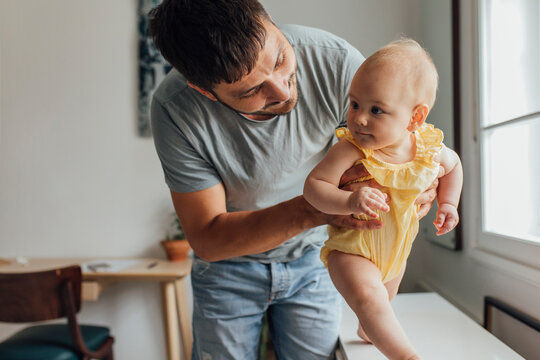 Father Is Helping In Babies First Steps