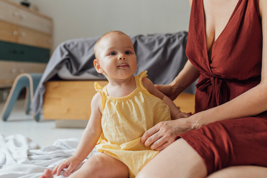 Motherhood: Baby Is Having Great Time Playing On The White Blanket