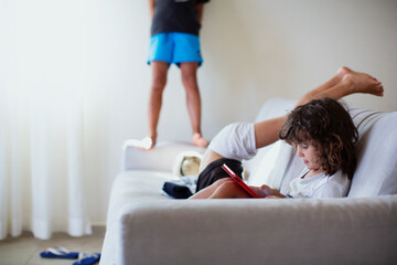 Three year old boy  using a digital tablet