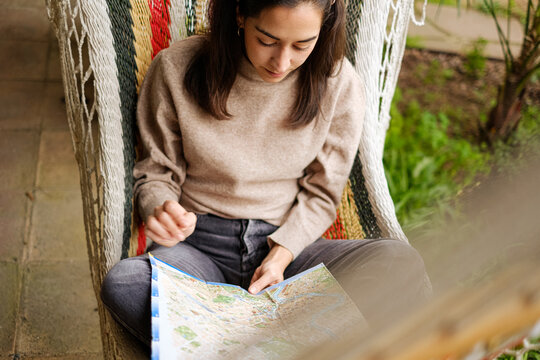 Young woman planning A Trip With A Map 