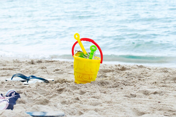 Summer beach toys and flip flops on the beach. holiday and vacations concept.