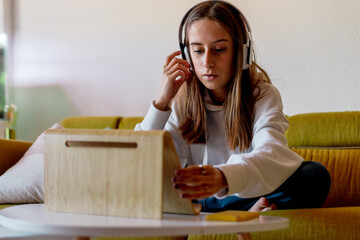 Teen girl doing homework at home online
