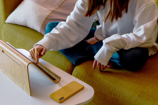 Teenager doing homework online at home with her tablet