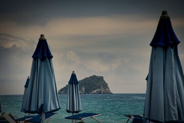 sunbeds and umbrellas on a Ligurian beach on a hot summer day