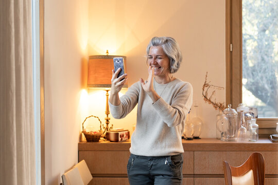 Happy mature woman making video call