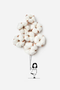 Girl holding dried cotton flowers as balloons