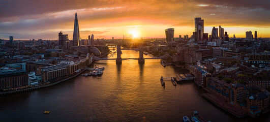 Panoramic aerial view to the modern skyline of London with the Tower Bridgeduring a colorful...
