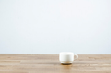 White cup of coffee on the table. On white background