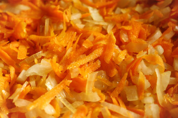 Color photograph of sliced carrots and onions. Healthy vegetables with vitamins. Vegetarianism and veganism.