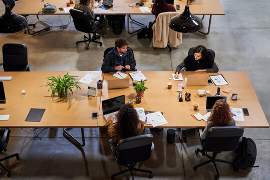 Four employee working at desk.