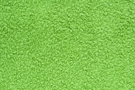 Green terry cloth towels. Textured and solid surface The image can be used as a texture or background. Copy space.