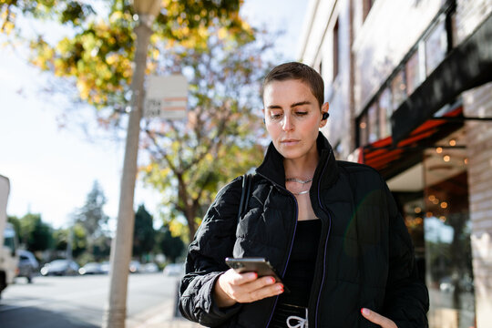 Woman Looks At Her Phone Outside 