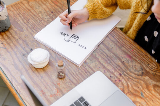 kid girl drawing a picture of germinated seeds learning botany online at home 