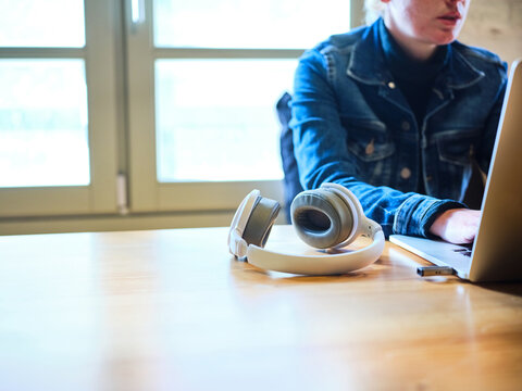 Headphones near girl using laptop