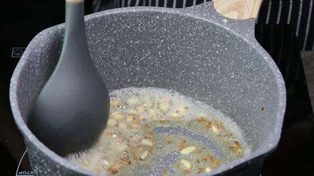 Preparing Tadka or Tempering for Daal tadka, an Indian lentil soup.