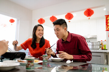 Family Laughs While Eating Dinner