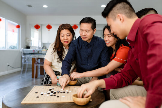 Chinese Family Enjoys a Board Game 