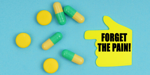 On a blue background, there are pills and a hand-sticker with the inscription - Forget the pain
