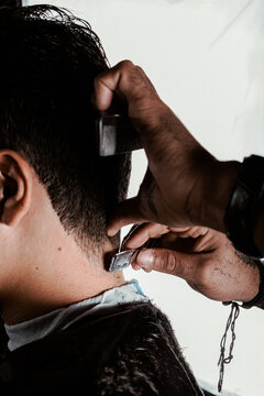 hairdresser cutting hair with razor-blade