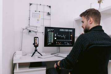 Financial specialist having video conference with colleague in workplace