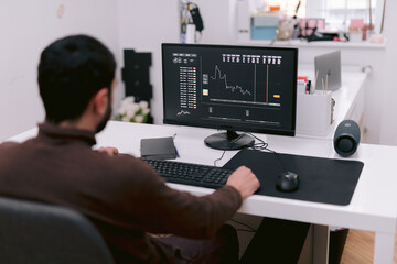 Trader working with charts on computer