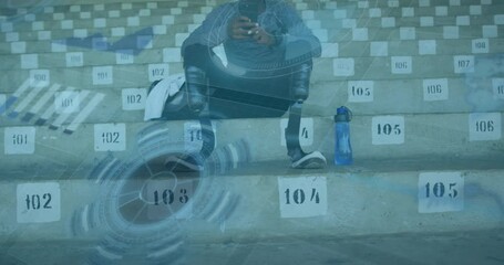 Animation of digital data processing over disabled male athlete in stands of sports stadium - Powered by Adobe