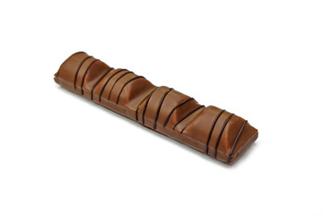 Black chocolate bar with soft hazelnut filling isolated on white background.