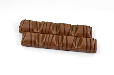 Black chocolate bar with soft hazelnut filling isolated on white background.