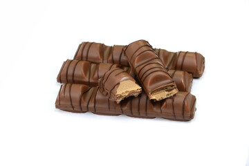 Black chocolate bar with soft hazelnut filling isolated on white background.