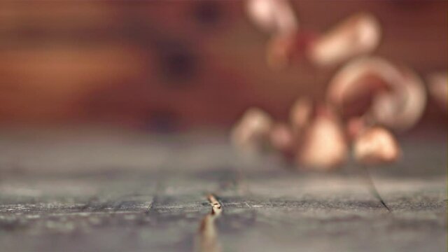 Super slow motion garlic cloves fall on a wooden table. Filmed on a high-speed camera at 1000 fps. High quality FullHD footage