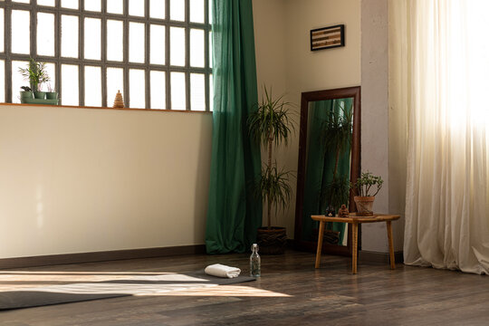 Empty yoga studio with mat 