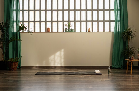 Empty yoga studio with mat 