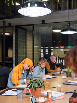 Diverse colleagues thinking and working in office